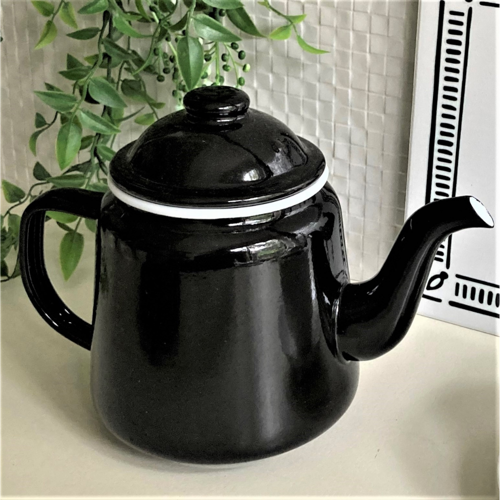 small shiny black enamel teapot with white rim on the lid
